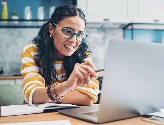 Employee working at a laptop in a bright office